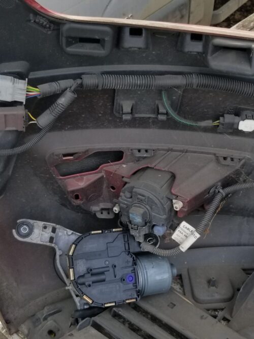 Close-up view of Citroën C4 Grand Picasso front bumper interior showing wiring harness, parking sensor, and motor assembly, genuine used part.