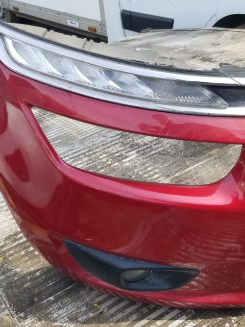 Right side view of used red front bumper for Citroën C4 Picasso 2015 – with fog light and trim