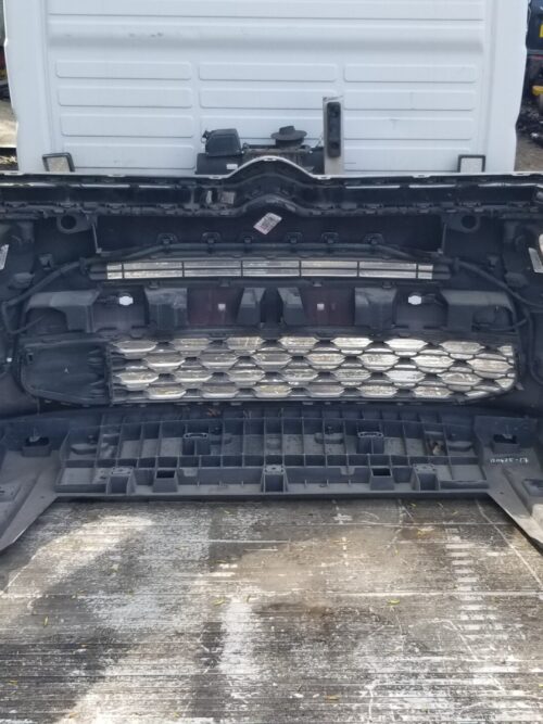 Inside view of Citroën C4 Grand Picasso front bumper showing mounting points, grille support, and integrated wiring components, used original part.