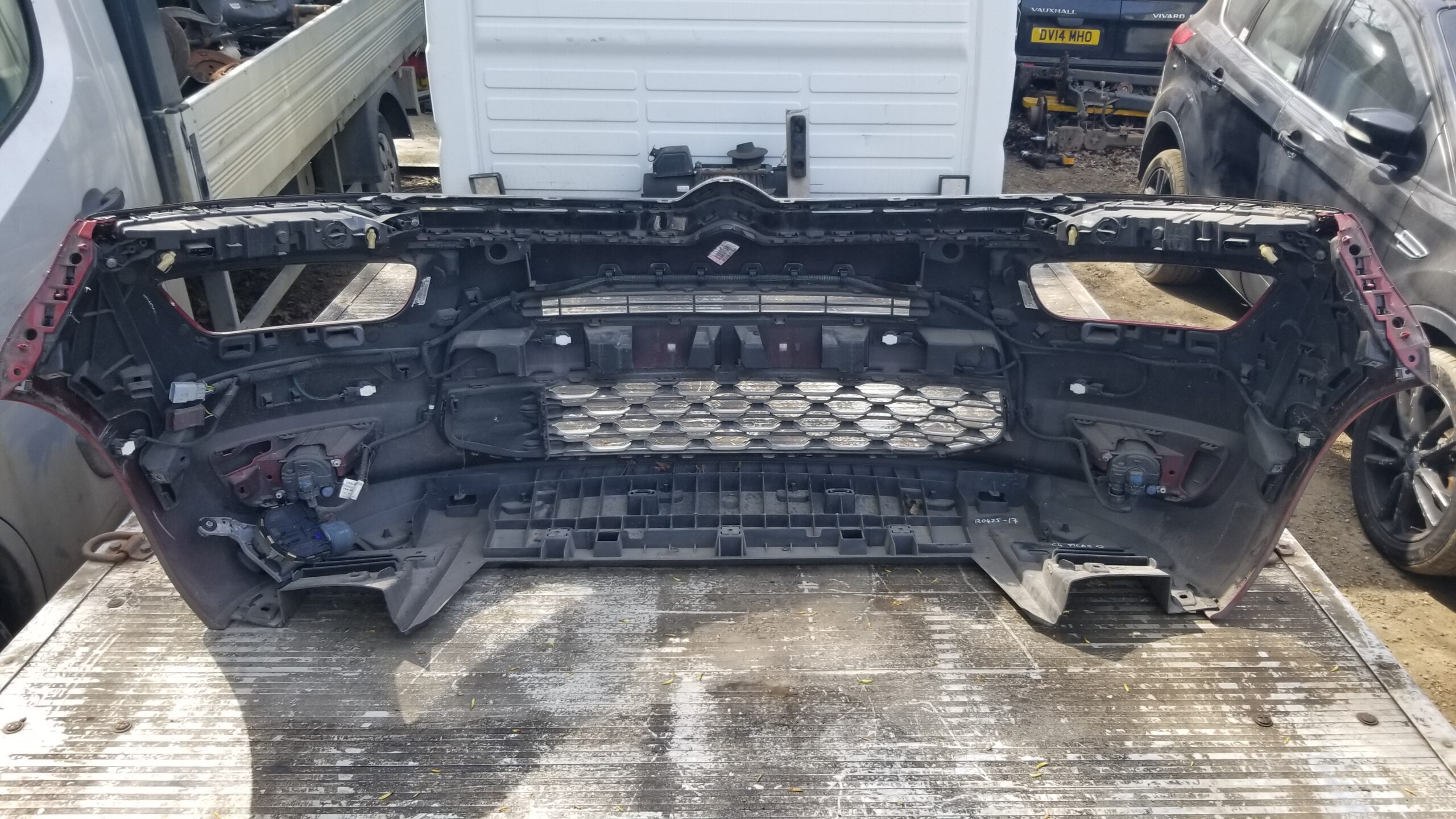 Inside view of Citroën C4 Grand Picasso front bumper showing mounting points, grille support, and integrated wiring components, used original part.