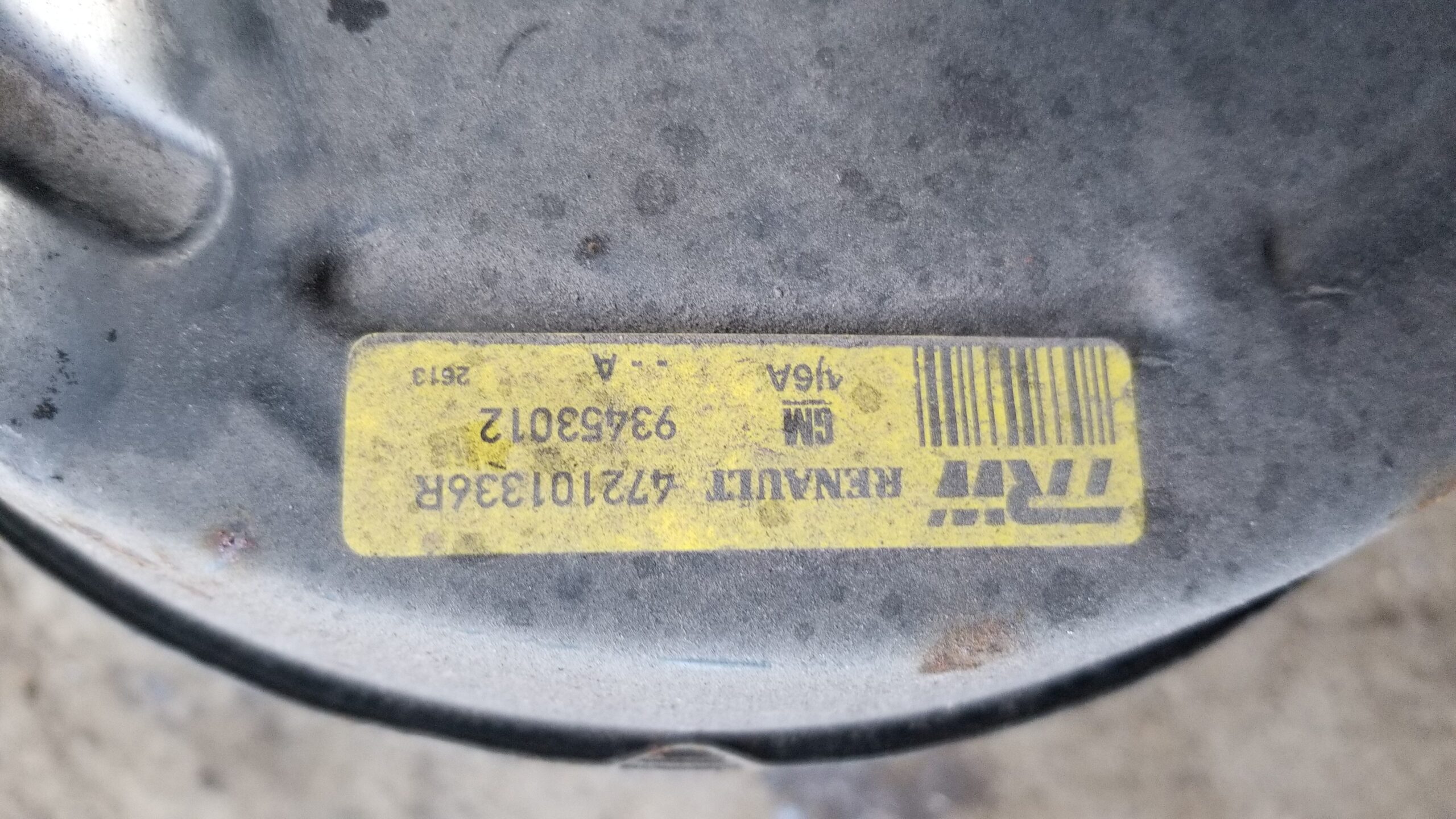 Close-up of part number 93453012 on brake servo cylinder