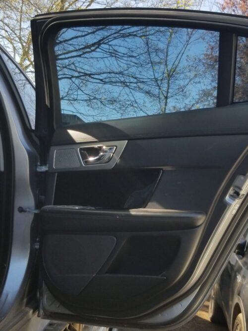 Interior panel view of 2013 Jaguar XF rear right door in grey