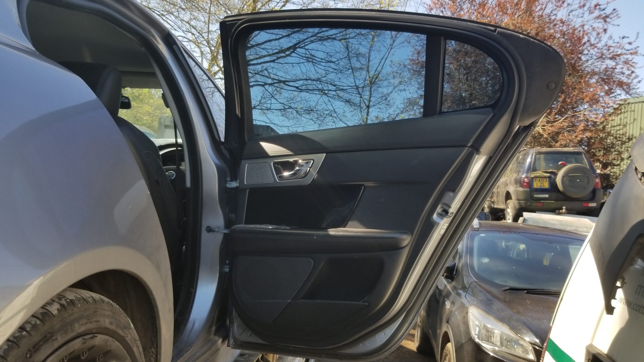 Interior panel view of 2013 Jaguar XF rear right door in grey