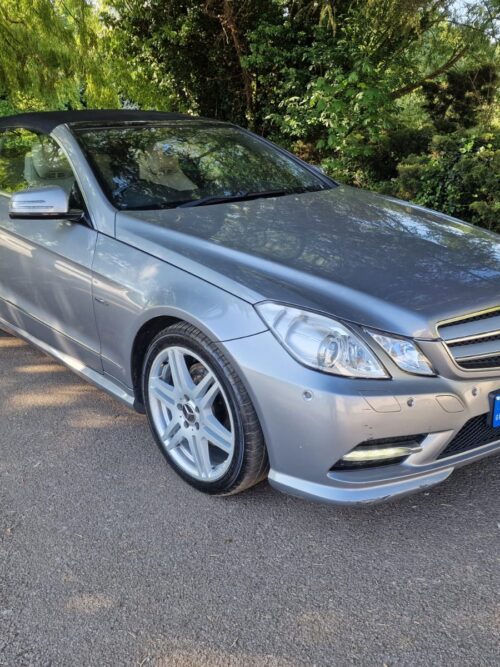 Front-side view of a silver 2012 Mercedes-Benz E-Class convertible parked in a shaded area – Vaz Auto UK used car parts and sales.