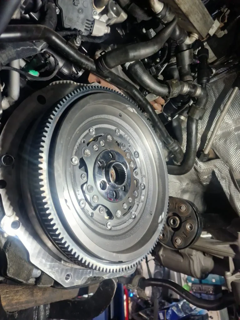 Close-up of a dual mass flywheel during replacement at VAZ Auto Corby car garage