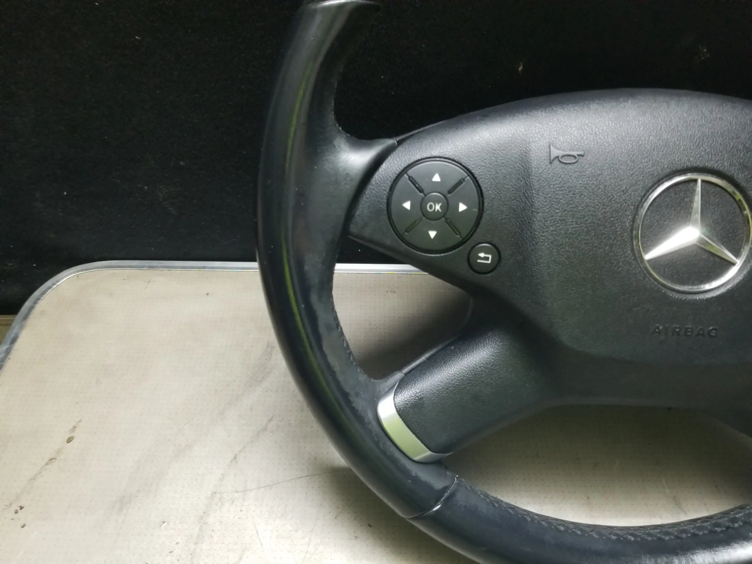 Mercedes W212 steering wheel control buttons close-up
