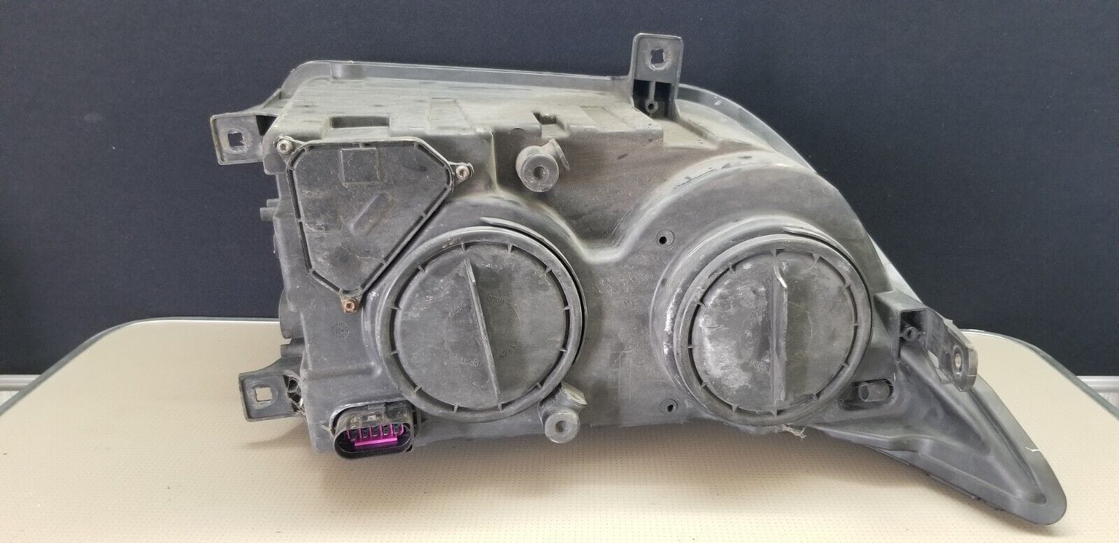 Rear view of VW Crafter right headlight assembly – used condition