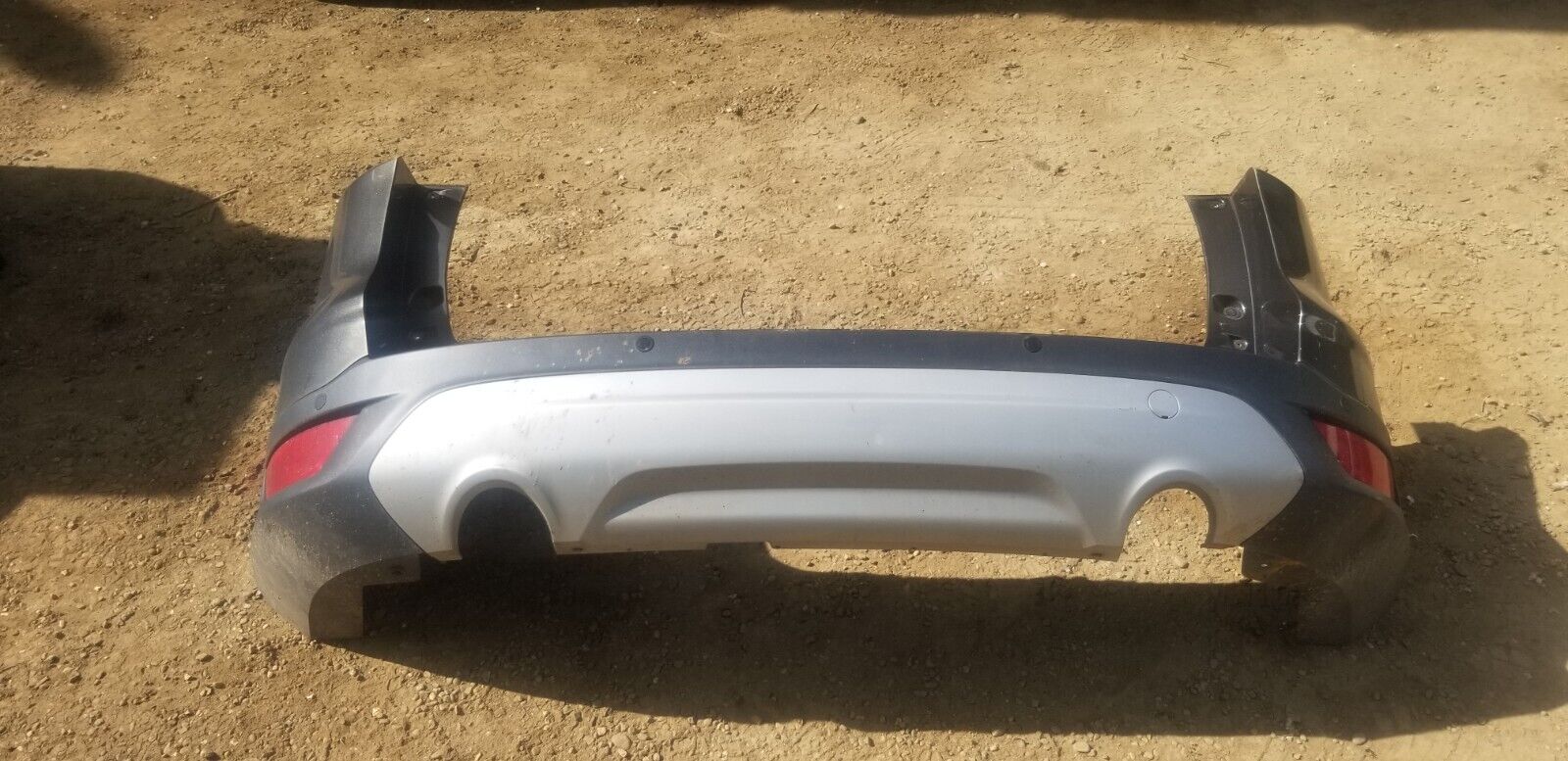 Condition close-up of used Ford Kuga 2016 Magnetic Grey rear bumper