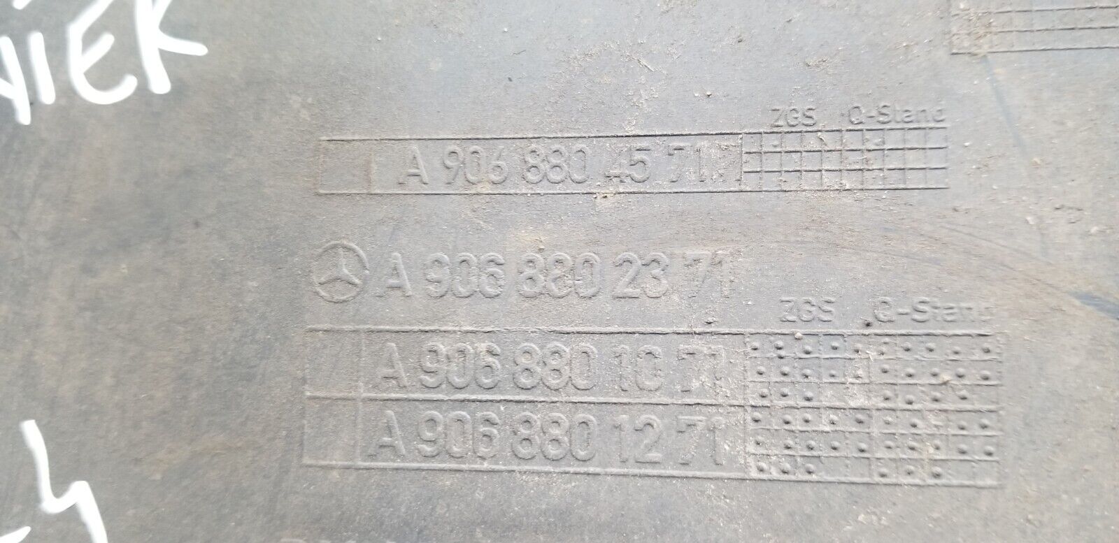 Close-up of part number A9068804571 on Mercedes Sprinter rear bumper