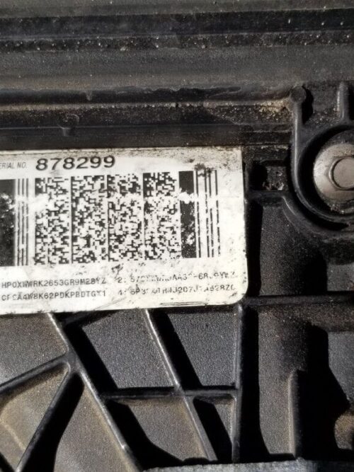 Close-up of engine identification plate displaying engine code