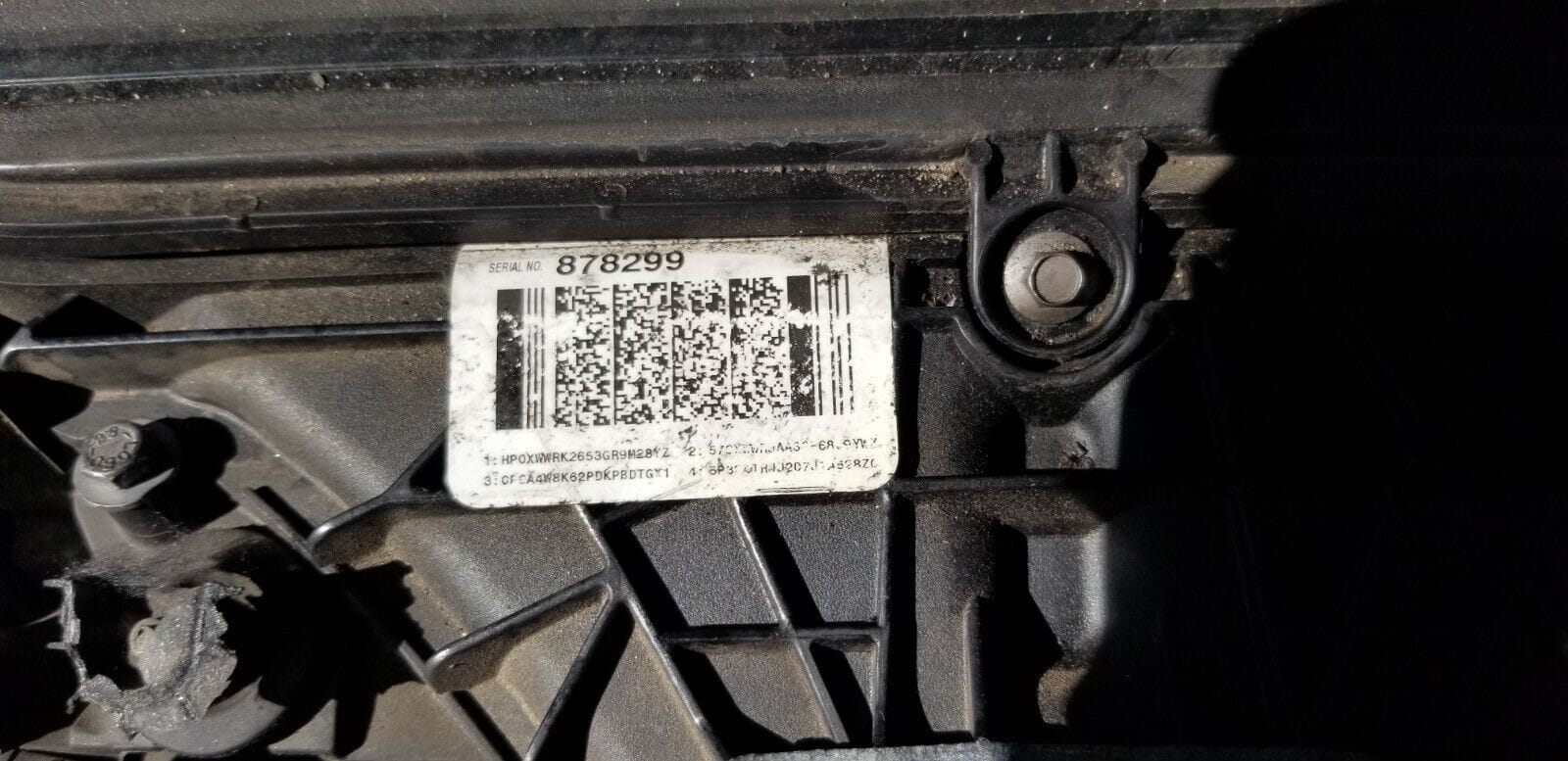 Close-up of engine identification plate displaying engine code