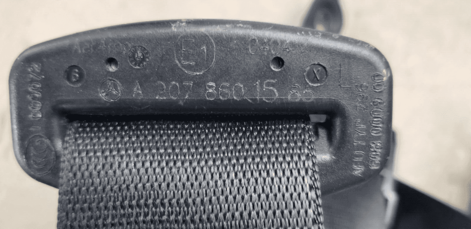 Label showing part number A2078601585 on seat belt assembly