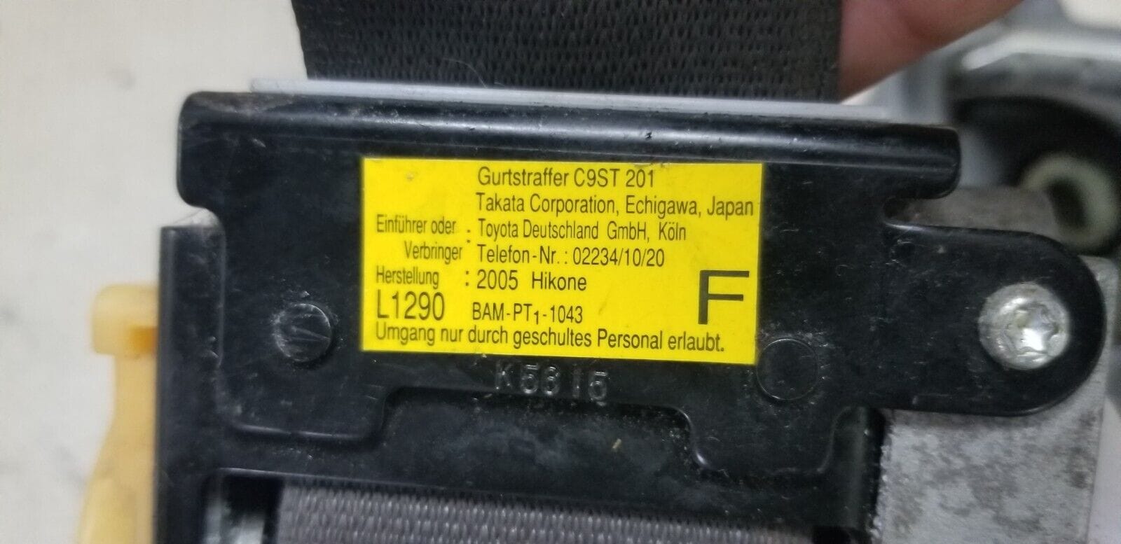 Close-up of TK-AF2-EF618-P info tag seat belt mechanism