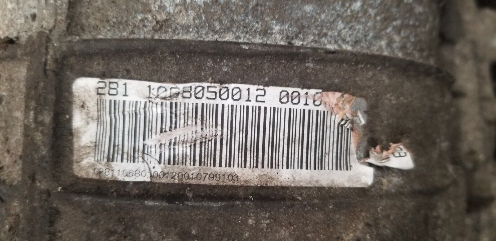 Label showing part number 1068050012 on X5 gearbox housing